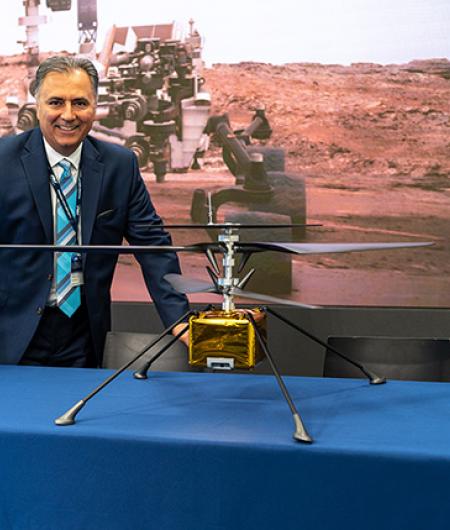 AV's CEO poses with a model of the Mars Helicopter. Photo: AeroVironment