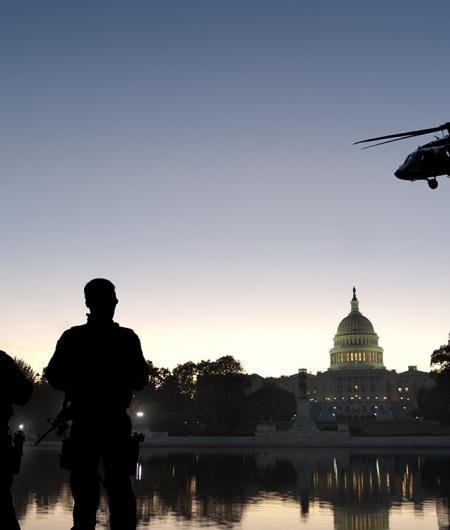 A stock photo of soldiers and a helicopter in front of the U.S. Capitol.