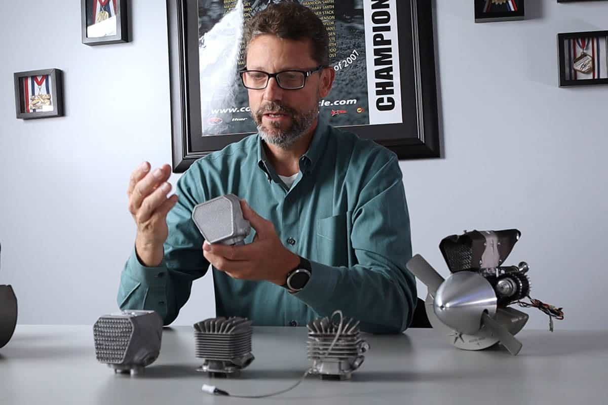 Cobra Aero president Sean Hilbert holding a 3D-printed engine cylinder with a unique interior lattice structure designed with nTopology computational-modeling software. 